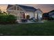 Inviting backyard with a stone patio, fire pit, string lights, and screened-in porch at 149 Country Mill Way, Fuquay Varina, NC 27526