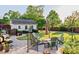 Backyard patio with a firepit, outdoor seating, and lush landscaping at 149 Country Mill Way, Fuquay Varina, NC 27526