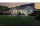 Well-maintained backyard with a patio, fire pit, string lights, and screened-in porch at 149 Country Mill Way, Fuquay Varina, NC 27526