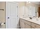 Bright bathroom with white cabinets, a single sink vanity, decorative candles, and a framed mirror at 149 Country Mill Way, Fuquay Varina, NC 27526