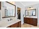 Bathroom with dual vanities, a large mirror, and access to a closet and shower at 149 Country Mill Way, Fuquay Varina, NC 27526