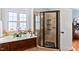 Bright bathroom featuring a soaking tub, a glass shower, and natural light at 149 Country Mill Way, Fuquay Varina, NC 27526