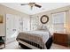 Comfortable bedroom featuring a metal bed frame, natural light, and an ensuite bathroom at 149 Country Mill Way, Fuquay Varina, NC 27526