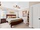 Cozy bedroom with a dark wood bed frame, ceiling fan, and soft natural light at 149 Country Mill Way, Fuquay Varina, NC 27526