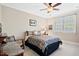 Neutral bedroom with a ceiling fan, queen bed, and plenty of natural light from the window at 149 Country Mill Way, Fuquay Varina, NC 27526