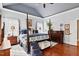 Primary bedroom with a sitting area, hardwood floors, and an ensuite bathroom at 149 Country Mill Way, Fuquay Varina, NC 27526