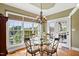 Bright dining room with a glass table, large windows, and a chandelier at 149 Country Mill Way, Fuquay Varina, NC 27526