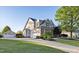 Spacious home featuring a three-car garage, brick accents, and well-maintained landscaping, enhancing its curb appeal at 149 Country Mill Way, Fuquay Varina, NC 27526