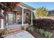 Cozy front porch featuring brick columns, rocking chairs, and lush landscaping, perfect for relaxation and curb appeal at 149 Country Mill Way, Fuquay Varina, NC 27526