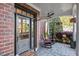 Charming front porch with rocking chairs, brick accents, and decorative plants, creating a welcoming and inviting entrance at 149 Country Mill Way, Fuquay Varina, NC 27526