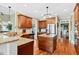 Spacious kitchen with center island, custom cabinetry, and hardwood flooring at 149 Country Mill Way, Fuquay Varina, NC 27526