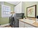 Functional laundry room featuring a washer, dryer, sink, and ample storage at 149 Country Mill Way, Fuquay Varina, NC 27526