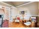 Cozy living room features hardwood floors, wainscoting, and multiple seating options at 149 Country Mill Way, Fuquay Varina, NC 27526