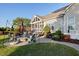 Outdoor patio area with a seating area, fire pit, and lush landscaping at 149 Country Mill Way, Fuquay Varina, NC 27526