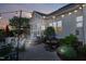 Backyard stone patio featuring outdoor dining area, cooking area and screened-in porch at 149 Country Mill Way, Fuquay Varina, NC 27526