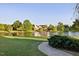 Peaceful pond view surrounded by lush landscaping and trees in the community at 149 Country Mill Way, Fuquay Varina, NC 27526