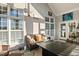 Bright screened porch with a couch, coffee table, and views of the backyard at 149 Country Mill Way, Fuquay Varina, NC 27526