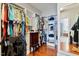 Organized walk-in closet with custom shelving, hanging rods, jewelry cabinet, and hardwood floors at 149 Country Mill Way, Fuquay Varina, NC 27526