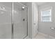 Bright bathroom with a glass enclosed shower and tiled floor at 166 Yellow Jacket Rdg, Clayton, NC 27520