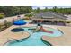 Community pool featuring a splash park with a slide and a separate swimming area under a blue umbrella at 166 Yellow Jacket Rdg, Clayton, NC 27520