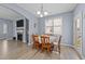 Bright dining area with a chandelier, hardwood floors, neutral walls, and a window at 166 Yellow Jacket Rdg, Clayton, NC 27520