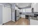 Modern kitchen with white cabinets, stainless steel appliances, granite countertops, and wood floors at 166 Yellow Jacket Rdg, Clayton, NC 27520
