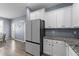Bright eat-in kitchen featuring stainless steel appliances, white cabinets, and granite countertops at 166 Yellow Jacket Rdg, Clayton, NC 27520