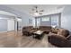 Open living room with hardwood floors, neutral walls, ceiling fan, and plenty of seating space at 166 Yellow Jacket Rdg, Clayton, NC 27520