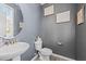 Stylish powder room featuring modern fixtures, a pedestal sink, and tasteful wall decor at 166 Yellow Jacket Rdg, Clayton, NC 27520