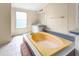 Bathroom showcasing a built-in tub, a window providing light, and a vanity at 1729 Crawford Rd, Graham, NC 27253
