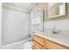 Bathroom with a tub, sink, and cabinet with storage shelving at 1729 Crawford Rd, Graham, NC 27253