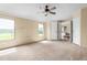 Inviting bedroom with a ceiling fan, neutral carpeting, and access to other rooms in the home at 1729 Crawford Rd, Graham, NC 27253