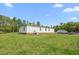 Exterior view of the house surrounded by greenery and a grassy yard at 1729 Crawford Rd, Graham, NC 27253