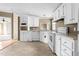 Functional kitchen with ample cabinetry, updated appliances, and durable flooring at 1729 Crawford Rd, Graham, NC 27253