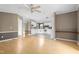Open-concept living area with hardwood flooring seamlessly transitioning into a white kitchen at 1729 Crawford Rd, Graham, NC 27253