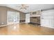 Cozy living room with a stone fireplace, built-in shelves, and laminate flooring at 1729 Crawford Rd, Graham, NC 27253