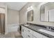 Bathroom featuring a soaking tub, double vanity with granite countertop, and modern lighting fixtures at 1730 Willie Pace Rd, Burlington, NC 27217