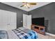 Comfortable bedroom features a TV and closet, perfect for relaxation and storage at 1730 Willie Pace Rd, Burlington, NC 27217