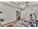 Bedroom with modern exercise equipment and a stylish desk with multiple monitors, illuminated by a ceiling fan at 1730 Willie Pace Rd, Burlington, NC 27217