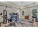 Bedroom featuring modern exercise equipment and a desk with multiple monitors, illuminated by a ceiling fan at 1730 Willie Pace Rd, Burlington, NC 27217