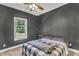 Cozy bedroom with natural light from the window and ceiling fan above at 1730 Willie Pace Rd, Burlington, NC 27217