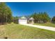 Well-maintained home featuring an attached garage and a long driveway, surrounded by mature trees at 1730 Willie Pace Rd, Burlington, NC 27217