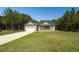 Inviting home with a two-car garage, long driveway, and a neatly kept front lawn, surrounded by trees at 1730 Willie Pace Rd, Burlington, NC 27217