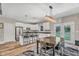 Bright, modern kitchen featuring a dark wood dining table and island with bar seating at 1730 Willie Pace Rd, Burlington, NC 27217