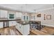 Open kitchen featuring white cabinets, stainless steel appliances, granite countertops, and an island with seating at 1730 Willie Pace Rd, Burlington, NC 27217
