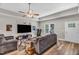 Comfortable living room features modern decor, a tray ceiling, and a view to the yard at 1730 Willie Pace Rd, Burlington, NC 27217