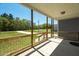 Inviting covered porch with wooden posts, railing, and views of the surrounding green lawn at 1730 Willie Pace Rd, Burlington, NC 27217