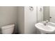 Powder room with white sink and toilet at 1850 Crissy Ln, Graham, NC 27253