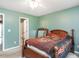 Bedroom with a wooden bed frame and a ceiling fan for added comfort at 1850 Crissy Ln, Graham, NC 27253