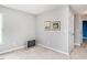Bright bedroom with neutral walls and flooring and a TV on the floor at 1850 Crissy Ln, Graham, NC 27253
